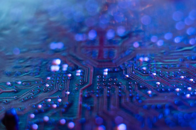 Computer motherboard microchips closeup in color illumination