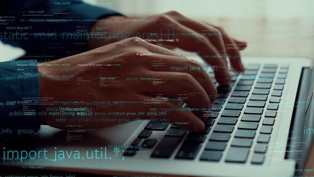 Computer programmer uses capable laptop computer to develop programming code