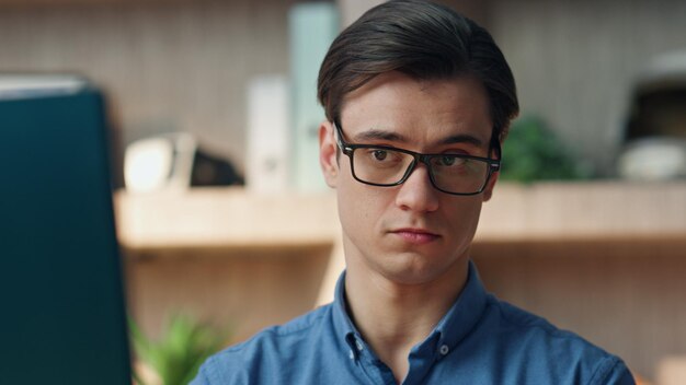 Confident creator making call at corporate office closeup man chatting phone