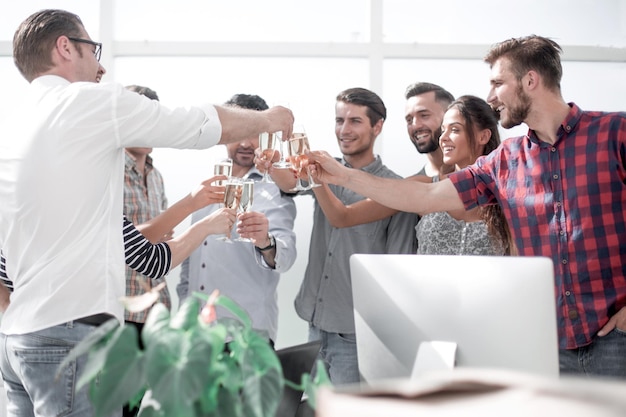 Creative business team raising their glasses of champagne