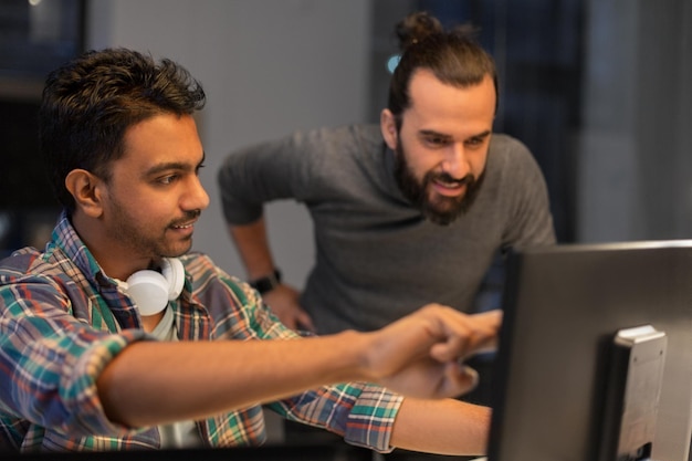 creative team with computer working late at office