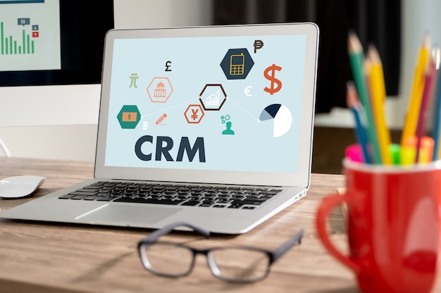 CRM Business Customer CRM Management Analysis Service Concept Business team hands at work with financial reports and a laptop