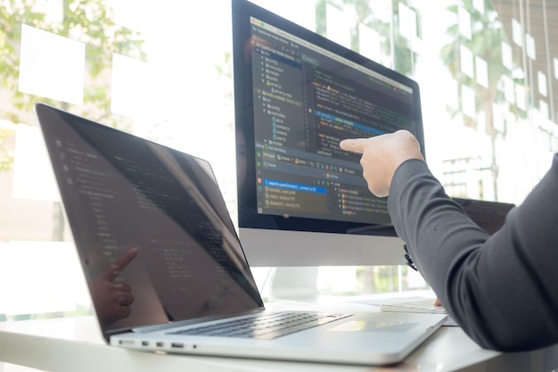 Cropped hand of computer programmers brainstorming in office