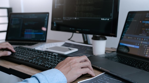 Cropped hands of businessman using computer at desk in office