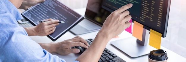 Cropped hands of people working on table