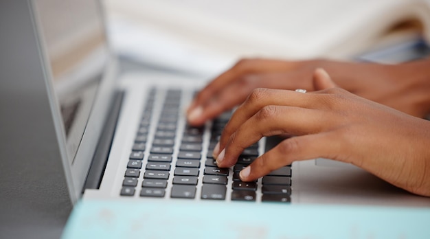 Cropped hands using laptop