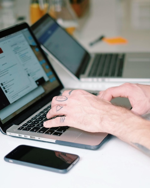 Cropped image of man using laptop