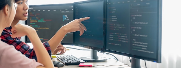 Cropped image of professional programer team collaboration discuss about web coding while coworker point java script displayed on computer at modern company office Closeup Burgeoning