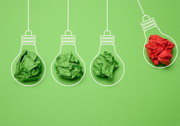Crumpled paper sheets inside a drawn light bulb concept of new creative idea innovation