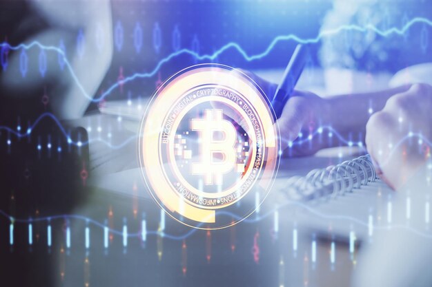 cryptocurrency hologram bitcoin ico theme over hands taking notes background concept of blockchain multi exposure