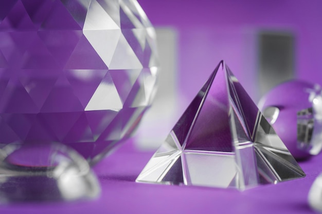 Crystal prism refracting light magic crystals and pyramid sphere and cube on purple background Spiritual healing crystal practice Feng Shui good energy flow concept backgroundxAxA