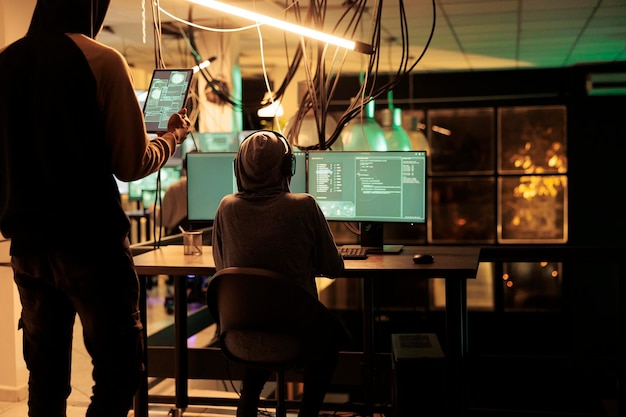 Cyberattack, hackers running spyware code on computer screen, hacking database, stealing electronic information. Cyberterrorism, data breach, internet scammers breaking into online server