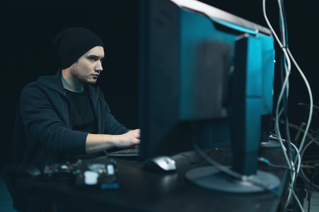 Dangerous hooded hacker breaks into government data servers and infects their system with a virus hi