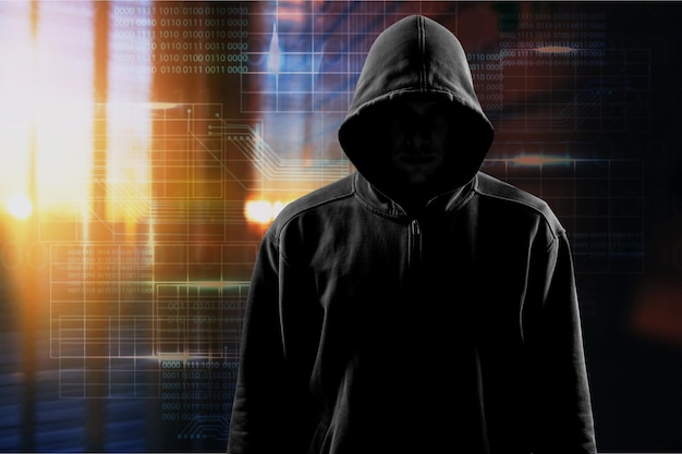 Dark unrecognisable man in hoodie on background