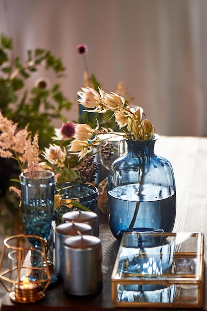 decoration table newlyweds blue dishes bottles of flowers and candleswedding floristry