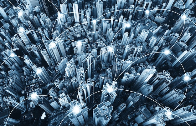 Digital composite image of dots connecting illuminated buildings in city at night