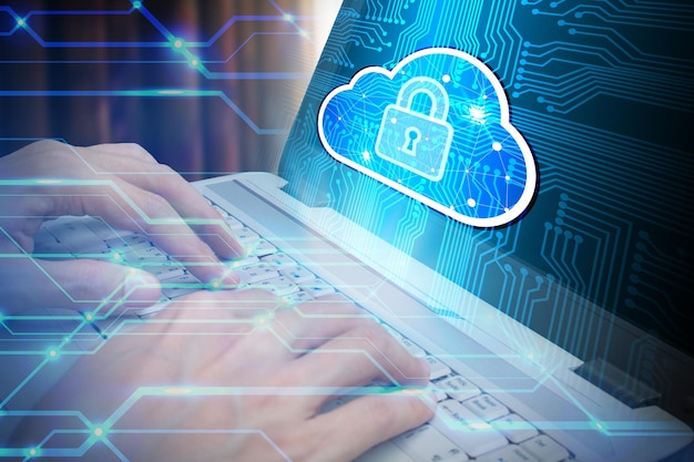 Digital composite image of hands using laptop with padlock icon