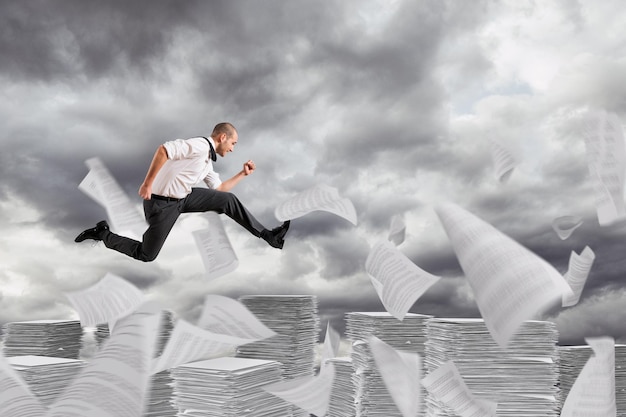 Digital composite image of man with arms raised against sky