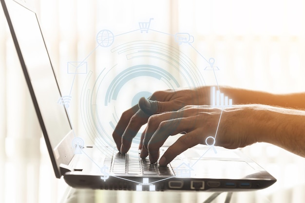 Digital composite image of person using laptop and icons
