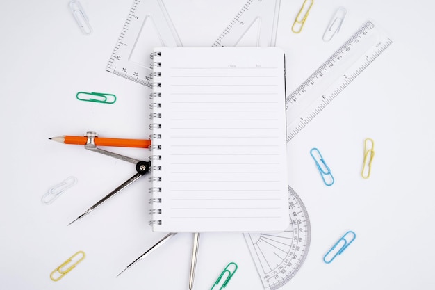 directly above shot of school supplies over white background