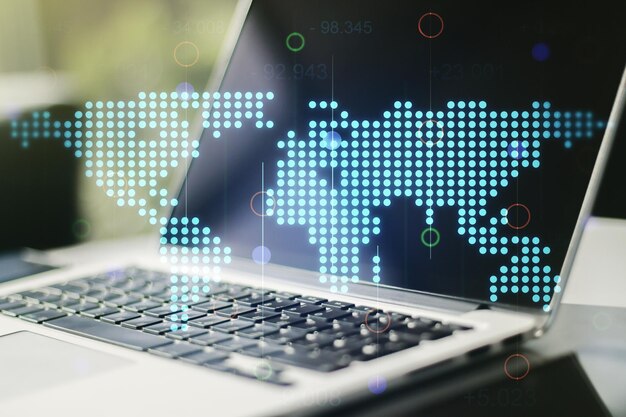 Double exposure of abstract digital world map on laptop background research and strategy concept