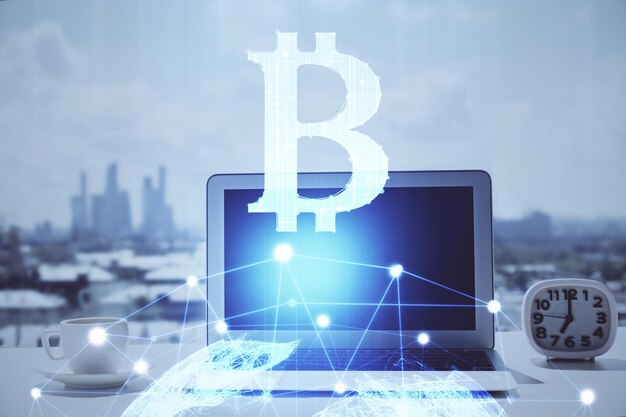 Double exposure of blockchain and crypto economy theme hologram and table with computer background Concept of bitcoin cryptocurrency