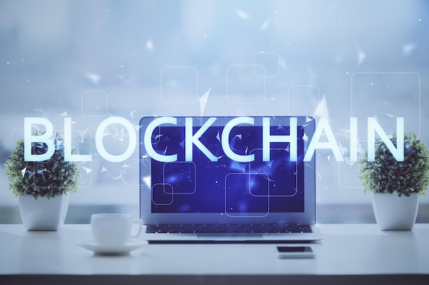 Double exposure of blockchain and crypto economy theme hologram and table with computer background Concept of bitcoin cryptocurrency