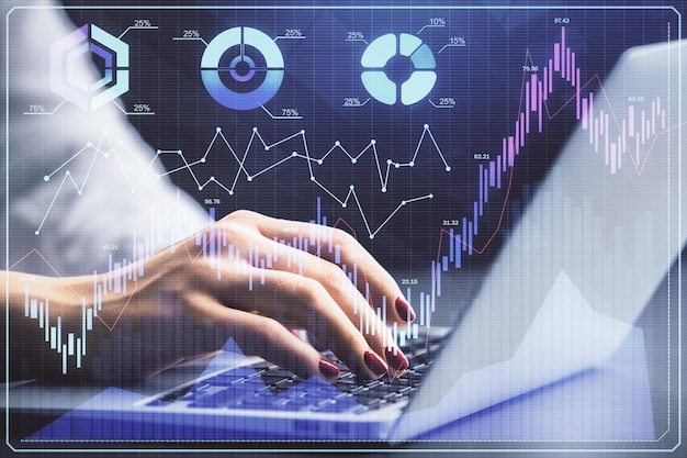 double exposure of businesswoman hands typing on computer and forex chart hologram drawing financial analysis concept