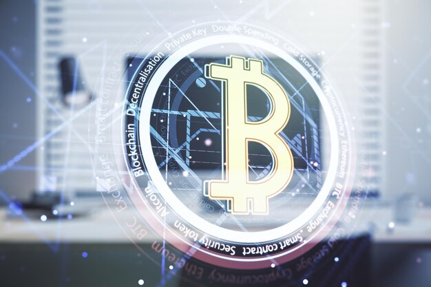 Double exposure of creative Bitcoin symbol with modern laptop on background Cryptocurrency concept