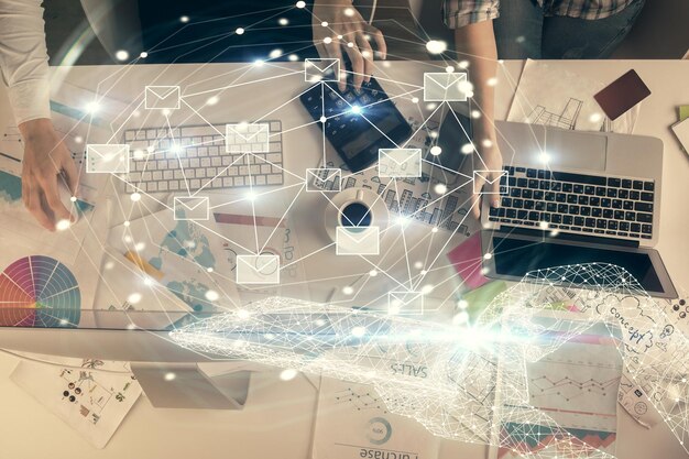 Double exposure of man and woman working together and envelop hologram drawing email concept Computer background