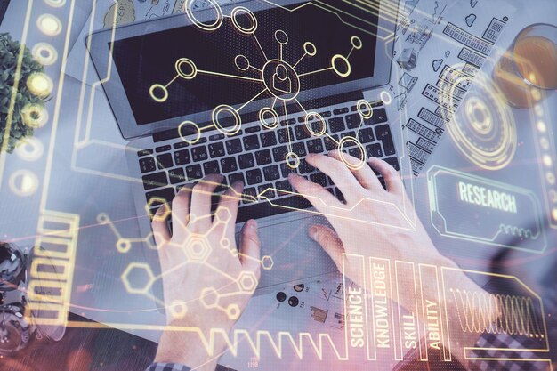 Double exposure of man's hands typing over computer keyboard and data theme hologram drawing Top view Technology concept