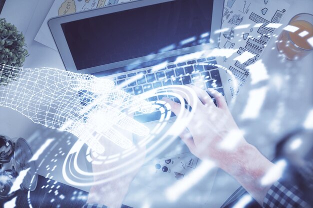 Double exposure of mans hands typing over computer keyboard and data theme hologram drawing Top view Technology concept