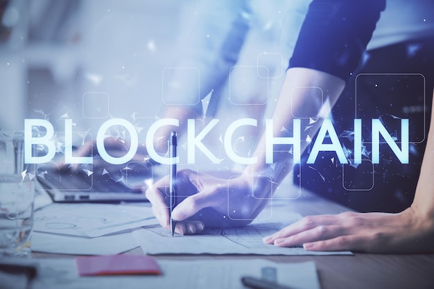 Double exposure of woman hands typing on computer and crypto market theme hologram drawing Blockchain concept