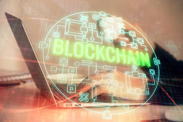 Double exposure of woman hands typing on computer and crypto market theme hologram drawing Blockchain concept