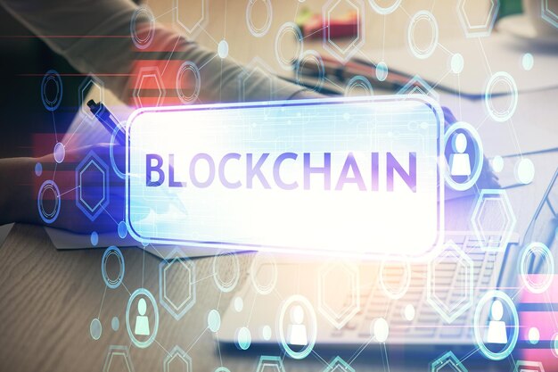 Double exposure of woman hands typing on computer and crypto market theme hologram drawing Blockchain concept