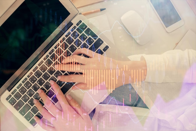 double exposure of woman hands working on computer and forex chart hologram drawing top view financial analysis concept
