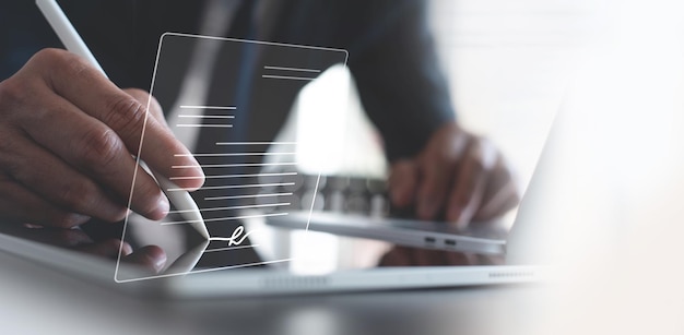 Esigning electronic signature document approve paperless office concept Businessman using stylus pen signing on edocument on digital tablet with digital business contract on virtual screen