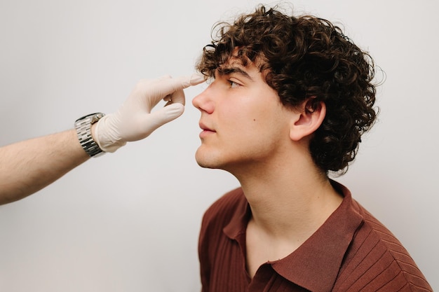 examination of the nasal septum to determine the patients problem process of consultation of an ent doctor consulting patient before rhinoplasty