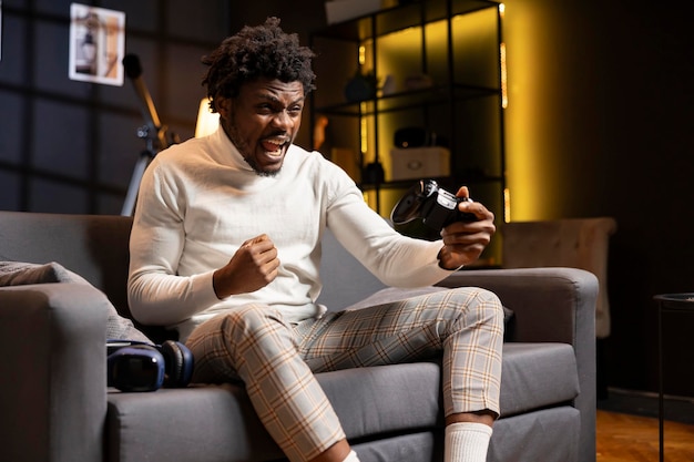 Excited gamer screaming from joy after winning gaming console game in living room