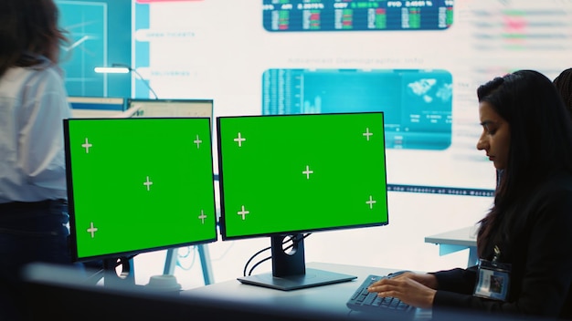 Executive officer analyzing greenscreen on monitors at his workstation