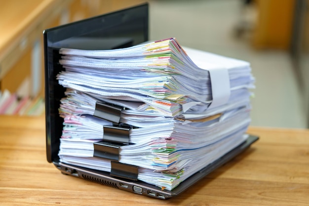 File in database stack of document pace on laptop on the desktop
