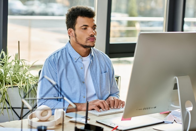 Focused young man working diligently at a modern desk in a bright office space