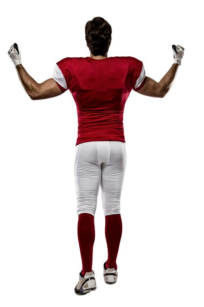football player with a red uniform walking, showing his back on white