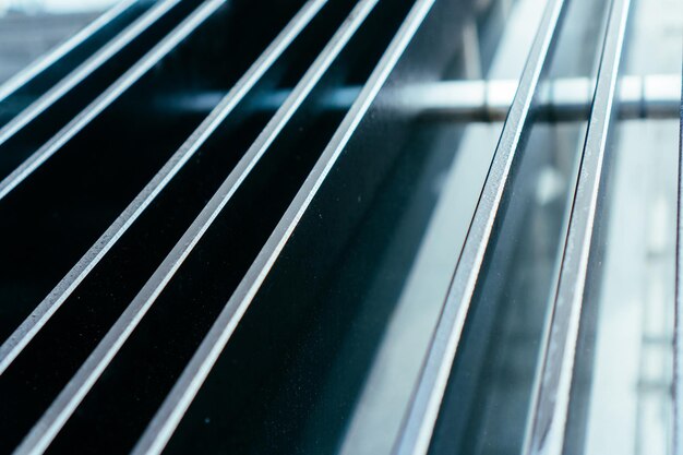 Forced glass handrail in parallel lines in office building Close up view