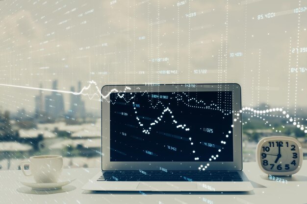 Forex graph hologram on table with computer background Multi exposure Concept of financial markets