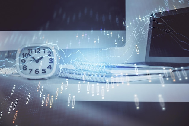 Forex graph hologram on table with computer background Multi exposure Concept of financial markets