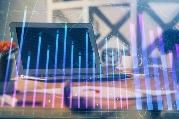 Forex market chart hologram and personal computer background Multi exposure Concept of investment