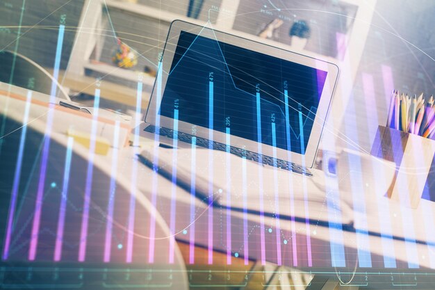 Forex market graph hologram and personal computer on background Multi exposure Concept of investment