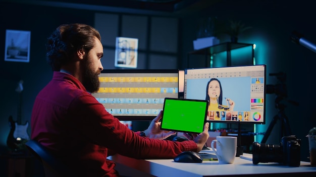 freelancer following tutorial on green screen tablet learning how to build digital portfolio showcasing edited images photo editor watching guide on mockup device about using retouching software
