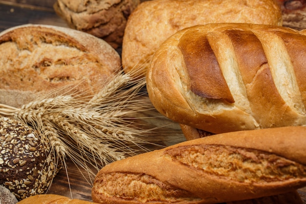 Fresh loaves of bread on wood
